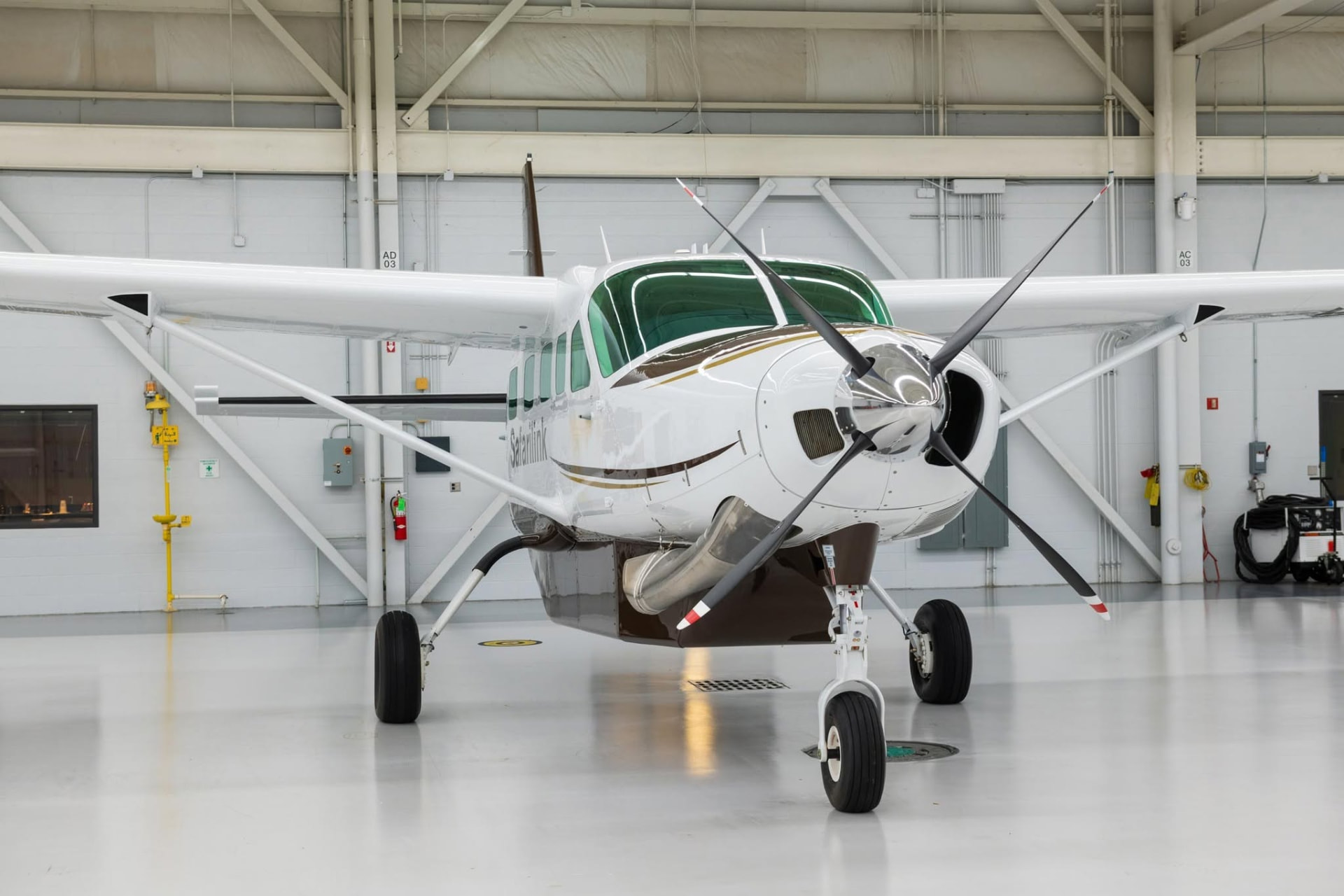 Safarilink Cessna Caravan parked inside a maintenance hangar